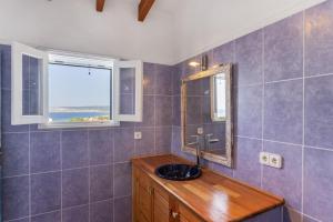 a bathroom with a sink and a mirror at Ses Roques Casa del Sol in Illes Balears +27 photos