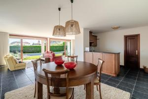 a kitchen and dining room with a table and chairs at Quinta do Outeirinho - Villa Deluxe in Celorico de Basto