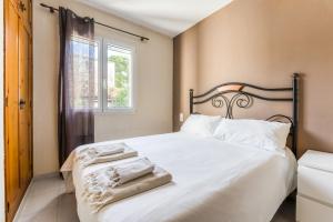 a bedroom with a bed with white sheets and a window at Green Park B18 in Son Parc +19 photos
