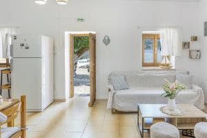 a living room with a couch and a refrigerator at Peter's Paradise in Telendos