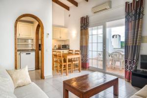 a living room with a couch and a table at Green Park B18 in Son Parc