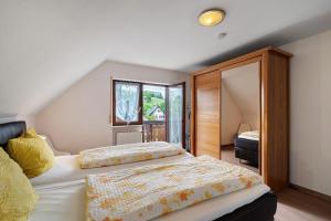 a bedroom with two beds and a large window at Ferienwohnung Serr in Lauf