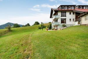 a house on a hill with a green field at Fewo Weitblick - Haus Sommerberg in Baiersbronn