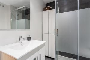 a white bathroom with a sink and a shower at Can Maryel in Tossa de Mar +14 photos