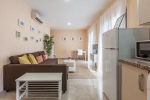 a living room with a couch and a refrigerator at Freedom Penthouse in Seville