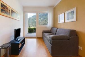 a living room with a couch and a television at Marinushof in Kastelbell-Tschars