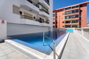 a swimming pool on the side of a building at Apartamento La Concha in Candelaria