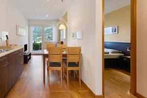 a kitchen and dining room with a table and chairs at Marinushof in Kastelbell-Tschars