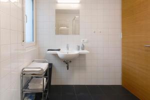 a white bathroom with a sink and a mirror at Marinushof in Kastelbell-Tschars +45 photos