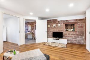 a living room with a brick wall at Ferienwohnung Seyfried in Hardheim