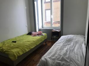 a small bedroom with a bed and a window at Vacance 16 Pers in La Bourboule