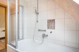 a shower with a glass door in a bathroom at Ferienwohnung Meeresbrise in Grömitz +19 photos