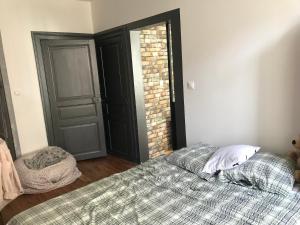a bedroom with a bed and an open door at Vacance 16 Pers in La Bourboule +3 photos