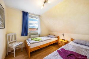 a bedroom with two twin beds and a window at Ferienwohnung Meeresbrise in Grömitz