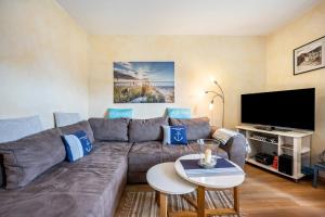 a living room with a couch and a flat screen tv at Ferienwohnung Meeresbrise in Grömitz