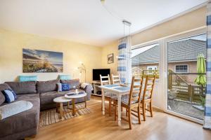 a living room with a couch and a table at Ferienwohnung Meeresbrise in Grömitz