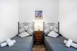 two beds sitting next to each other in a room at Casa Ale in Cádiz +16 photos