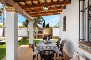 a dining room with a table and chairs on a patio at Casa Ale in Cádiz