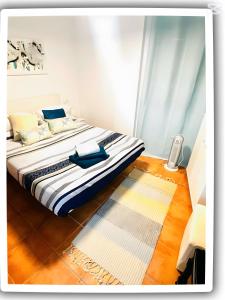 a bedroom with a large bed with a rug at Perlazul in Peniscola +37 photos