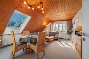 a kitchen and dining room with a table and chairs at Fischerhus Anne Jensen in Pellworm