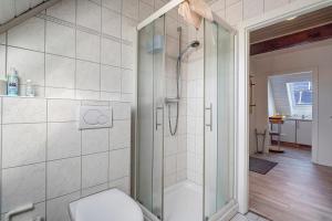 a bathroom with a shower and a toilet at Fischerhus Anne Jensen in Pellworm +22 photos