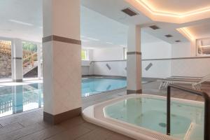 a large pool with a hot tub in a building at Ferienhaus Berger in Sarntal
