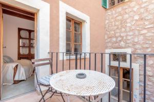 a balcony with a table and chairs on a building at Villa Can Got in Sóller