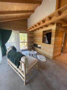 a bedroom with a bed in a wooden wall at Chalet Imbosc'chè 5 rooms Bnb in Livigno