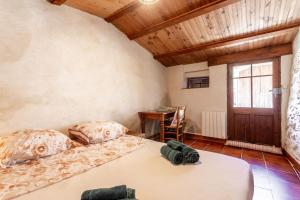a bedroom with two beds and a table in it at La Fenière - Maison avec terrasse in Collobrières