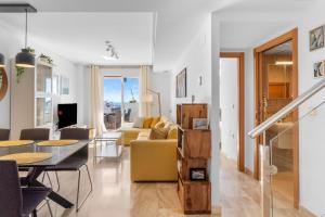 a living room with a yellow couch and a table at Vistolmar Tivoli A213 in Benalmádena