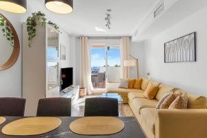 a living room with a couch and a table at Vistolmar Tivoli A213 in Benalmádena