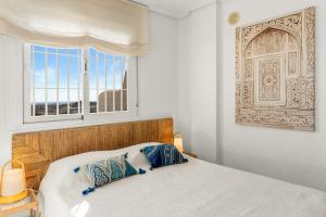 a white bedroom with a bed and a window at Vistolmar Tivoli A213 in Benalmádena +20 photos