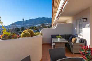 a balcony with a view of the mountains at Vistolmar Tivoli A213 in Benalmádena