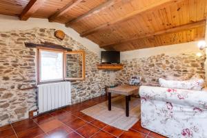 a living room with a couch and a window at La Fenière - Maison avec terrasse in Collobrières