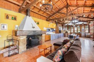 a living room with a couch and a fireplace at Finca Los Caleros - Algorfa in Algorfa