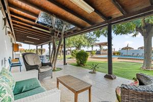 a patio with a couch and chairs and a table at Finca Los Caleros - Algorfa in Algorfa