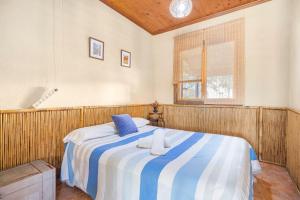 a bedroom with a large bed with blue and white sheets at Finca Los Caleros - Algorfa in Algorfa +32 photos