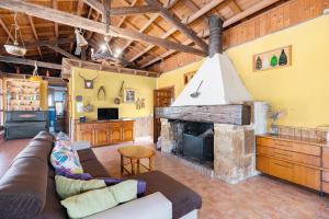 a living room with a couch and a fireplace at Finca Los Caleros - Algorfa in Algorfa