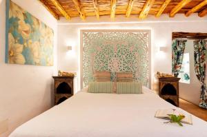 a bedroom with a bed with a white bedspread at Can Pep Den Sitges in Sant Joan de Labritja