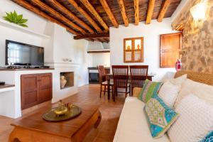 a living room with a couch and a table at Can Pep Den Sitges in Sant Joan de Labritja