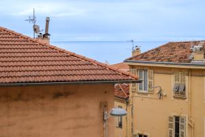 two buildings with red tile roofs and a street at Joli studio près de Monaco in Beausoleil
