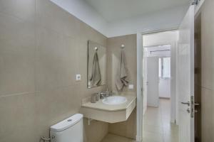 a bathroom with a sink and a toilet at Vv Brisamar in Telde +14 photos