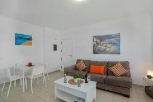 a living room with a couch and a table at Vv Brisamar in Telde