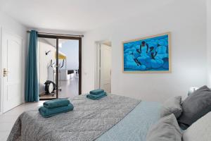 a bedroom with a bed with two pillows on it at Penthause Luxe 501 sea View pool in Playa Fañabe +15 photos