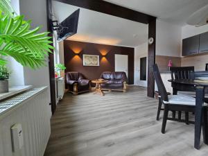 a living room and dining room with a table and chairs at Apartment - Tor zur Rhön in Vachat