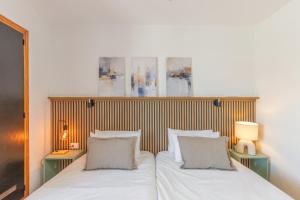 a bedroom with a bed with two lamps and two pillows at Arizona's Bay in Puerto Rico de Gran Canaria
