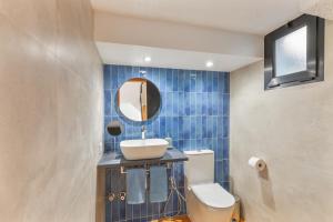 a bathroom with a sink and a toilet and a mirror at Arizona's Bay in Puerto Rico de Gran Canaria +23 photos