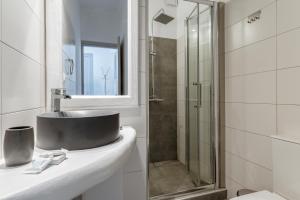a bathroom with a sink and a shower at Blue Waves View Andros in Andros +19 photos