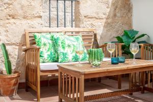 a wooden table with wine glasses on a patio at Casa Roques 16 in Jávea
