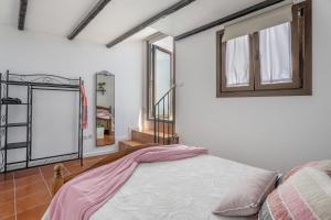 a bedroom with a bed and a window at Casa Abuelo Manuel in El Draguito +24 photos